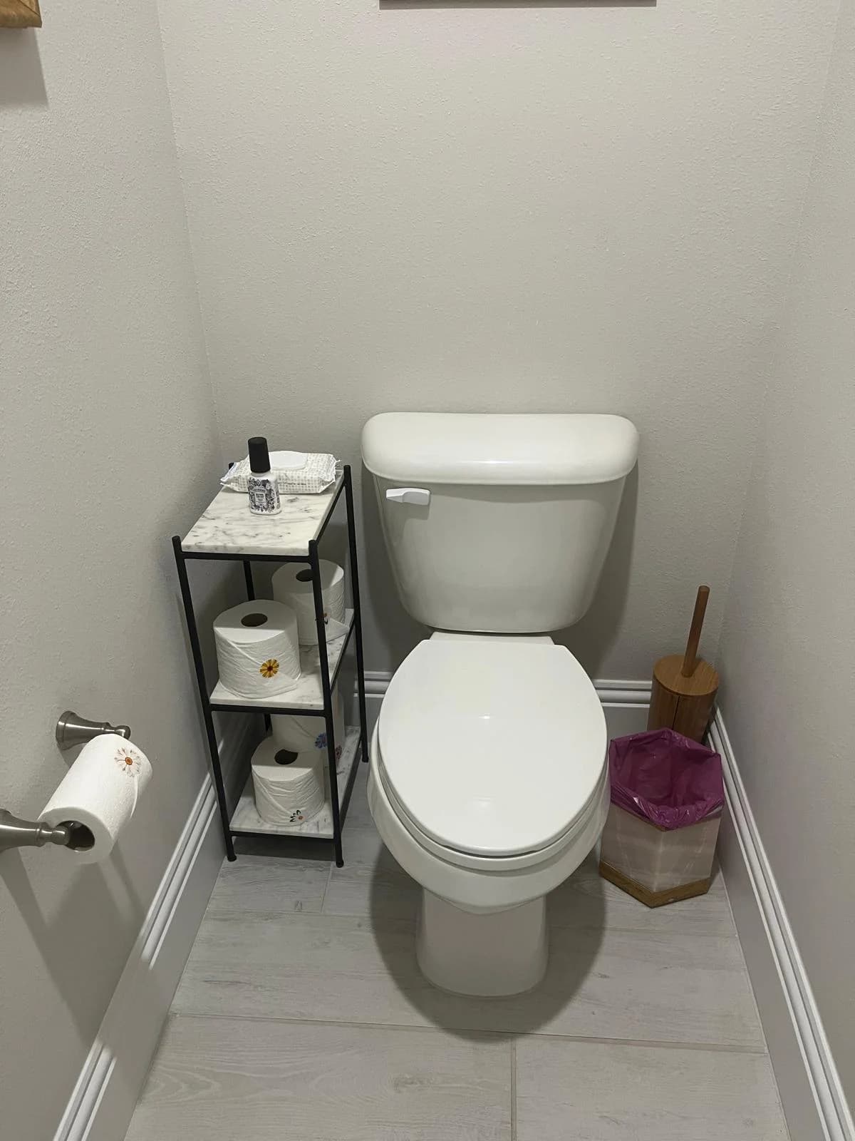 A bathroom shelf with neatly folded towels and toiletries.